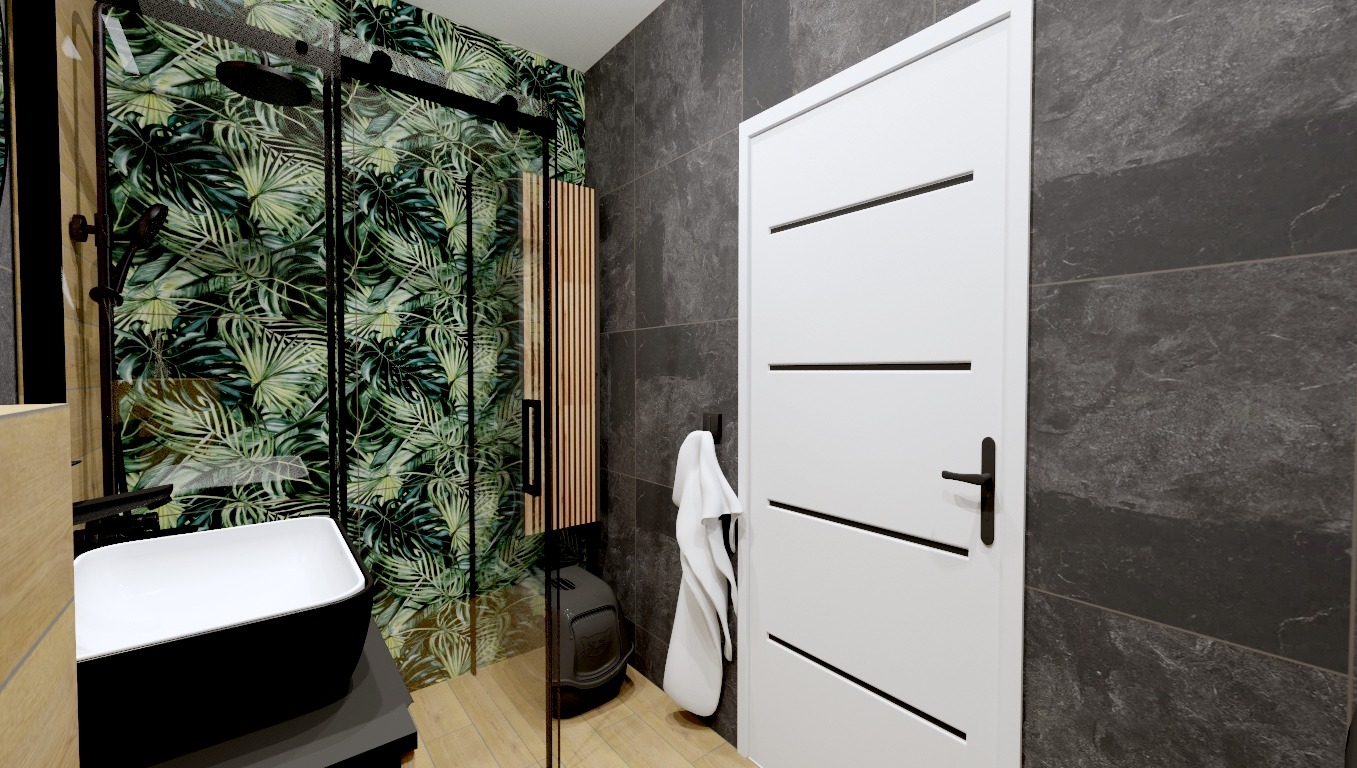 Nowoczesna łazienka z kabiną prysznicową w tropikalne liście, czarną armaturą, umywalką nablatową, szarą płytką imitującą kamień i białą, minimalistyczną stolarką drzwiową.