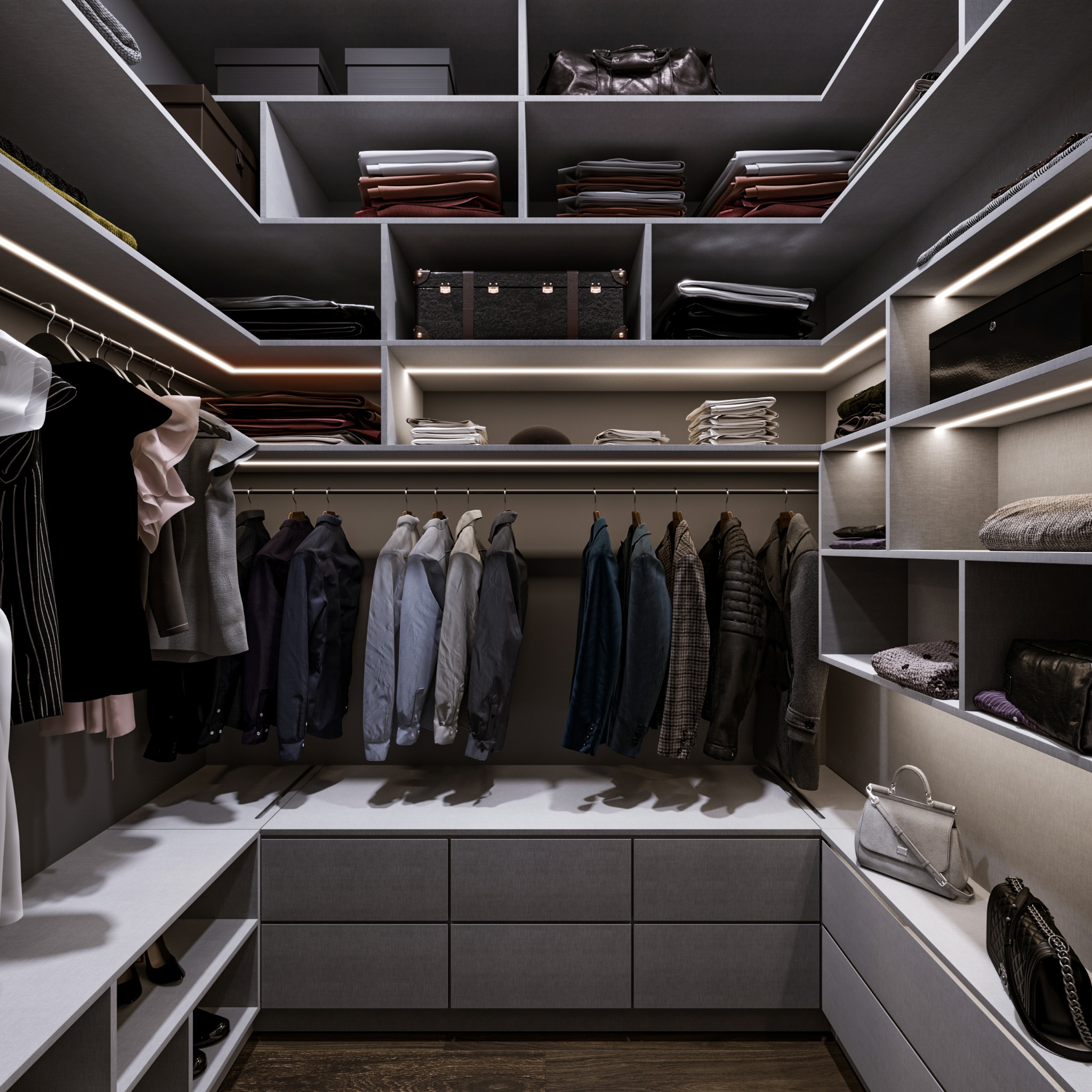 Wnętrze garderoby z szarymi szafkami, półkami podświetlonymi ledami, wiszącymi ubraniami oraz torebkami i walizkami na półkach.
