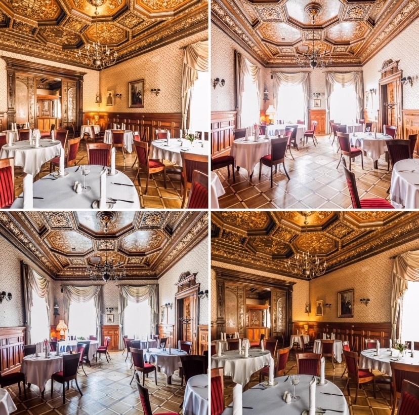 Elegancka sala restauracyjna z parkietem, okrągłymi stołami nakrytymi białymi obrusami, czerwonymi krzesłami i bogato zdobionym, kasetonowym sufitem z żyrandolem.