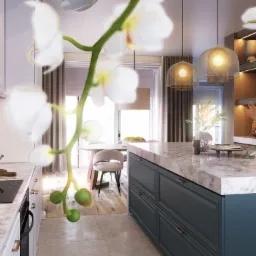 Nowoczesna kuchnia z wyspą o marmurowym blacie i ciemnych frontach, widok na okrągły stół jadalny i wiszące lampy z ażurowymi kloszami, z delikatnym motywem kwiatowym na pierwszym planie.