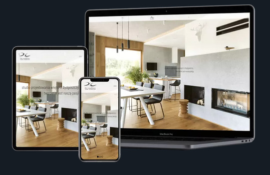 Responsywna strona internetowa studia projektowania wnętrz z Bydgoszczy, wyświetlana na laptopie, tablecie i smartfonie, prezentująca nowoczesne wnętrze z kominkiem i jadalnią.