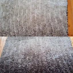 Dywan shaggy w odcieniach szarości, widoczne wyraźne różnice w kolorze po czyszczeniu, leżący na drewnianej podłodze.