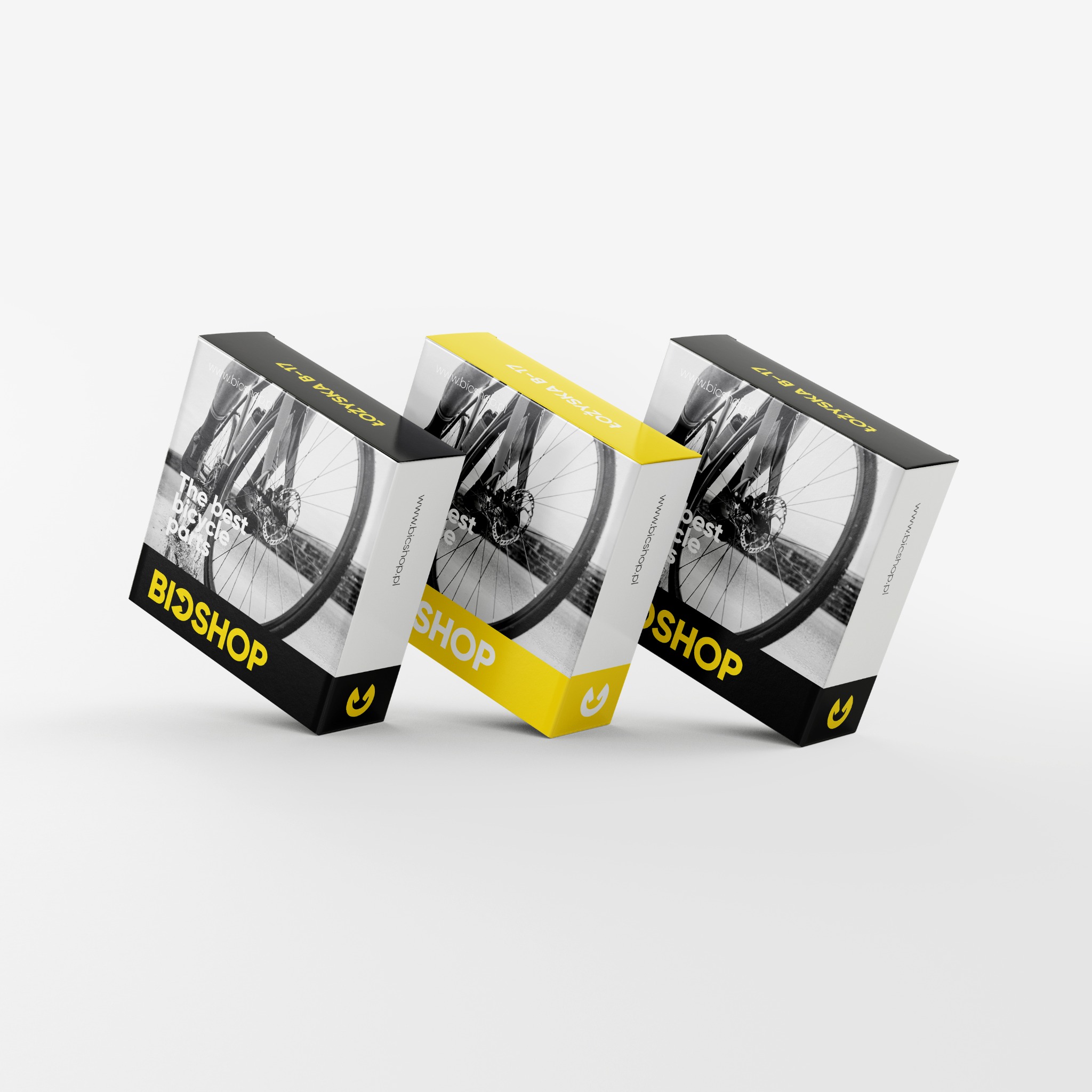 Trzy pudełka z grafiką roweru, czarno-białe i żółte, z logo BiOSHOP, prezentacja opakowań.
