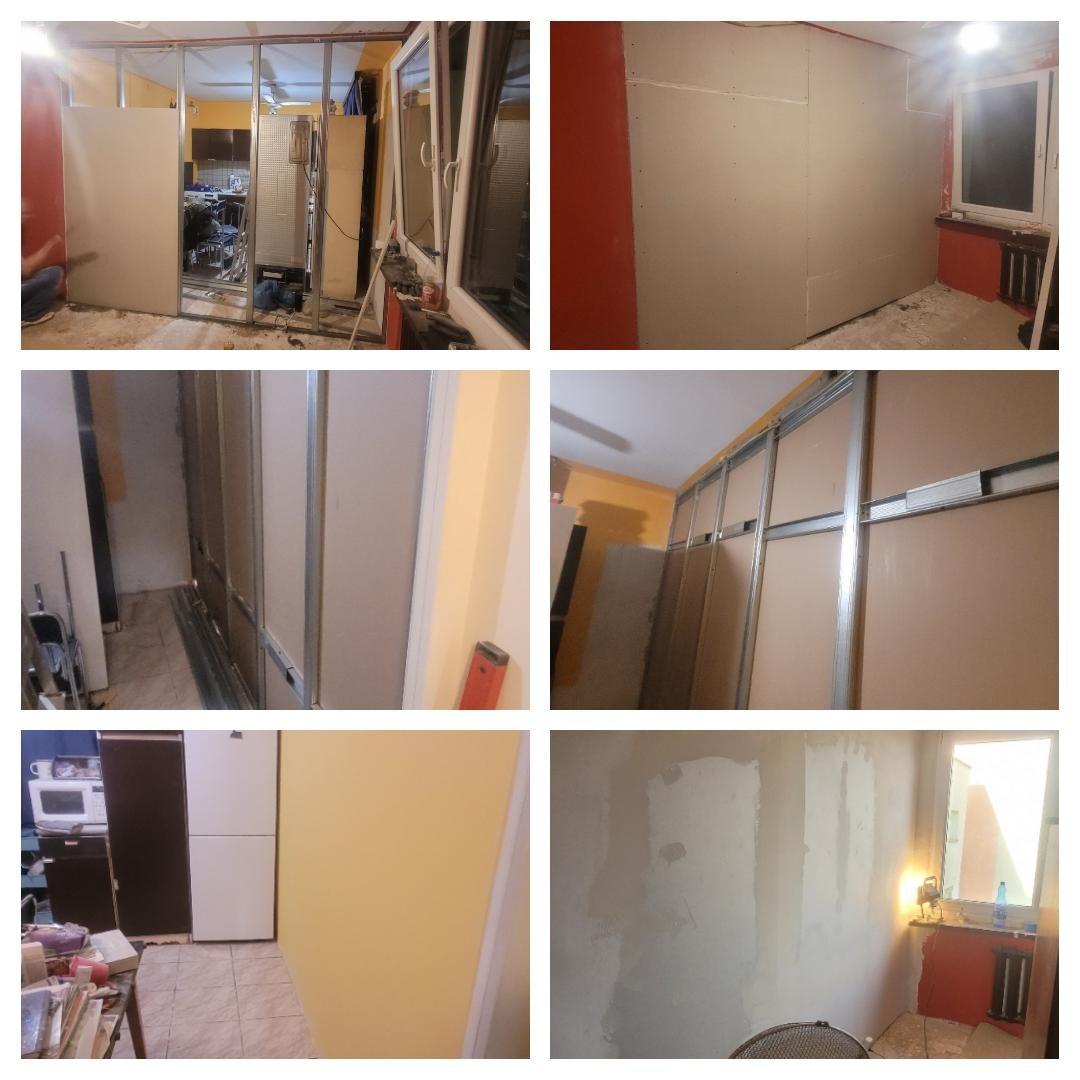 Wnętrze w trakcie prac wykończeniowych: widoczne metalowe profile konstrukcyjne, częściowo zamontowane płyty na ścianach, ślady po szpachlowaniu, okno z parapetem, fragment wyposażenia kuchni w tle.