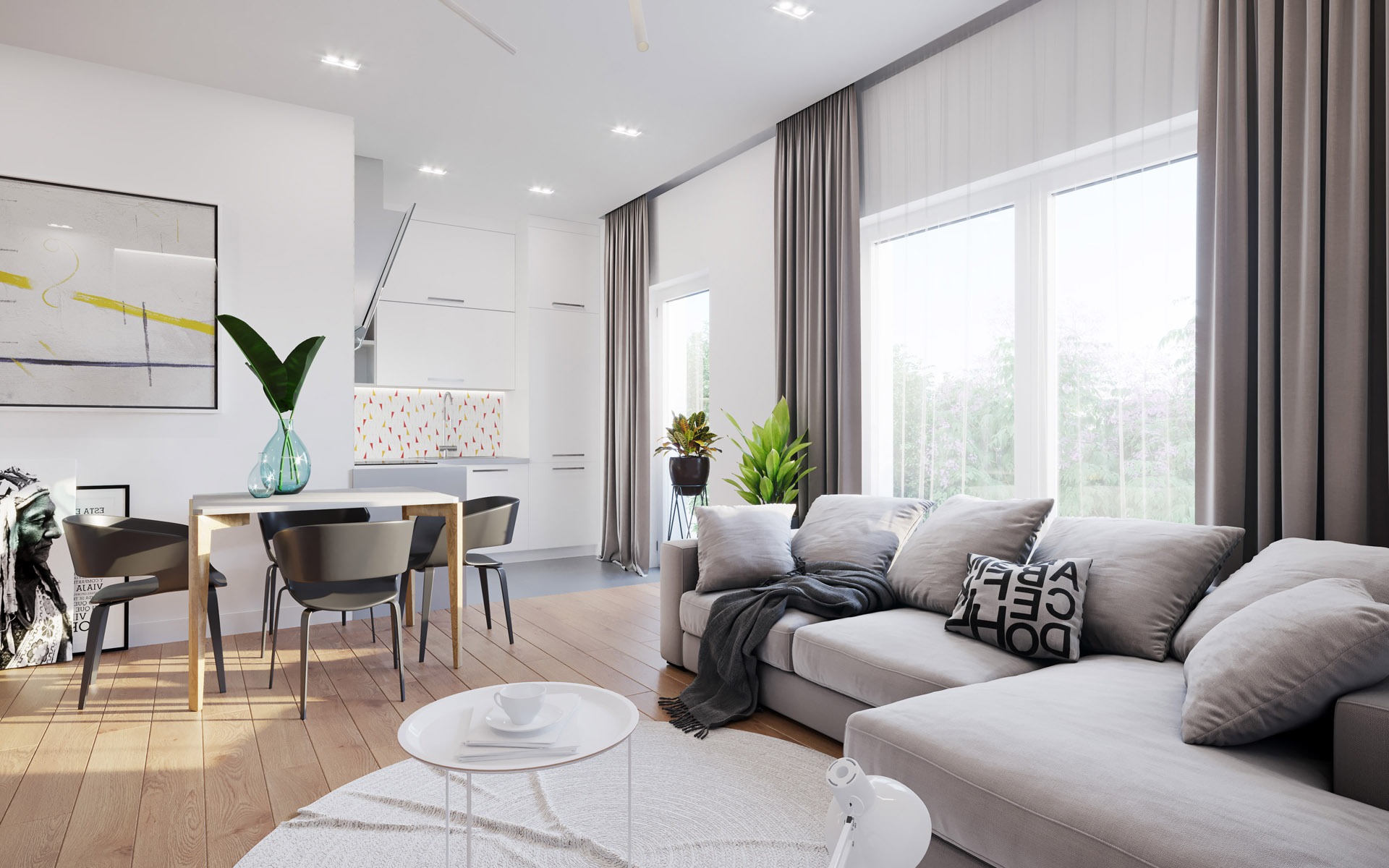 Jasne, nowoczesne wnętrze z szarym narożnikiem, drewnianym stołem i krzesłami, okrągłym stolikiem kawowym z filiżanką, oraz kuchnią w tle z kolorową mozaiką nad blatem.