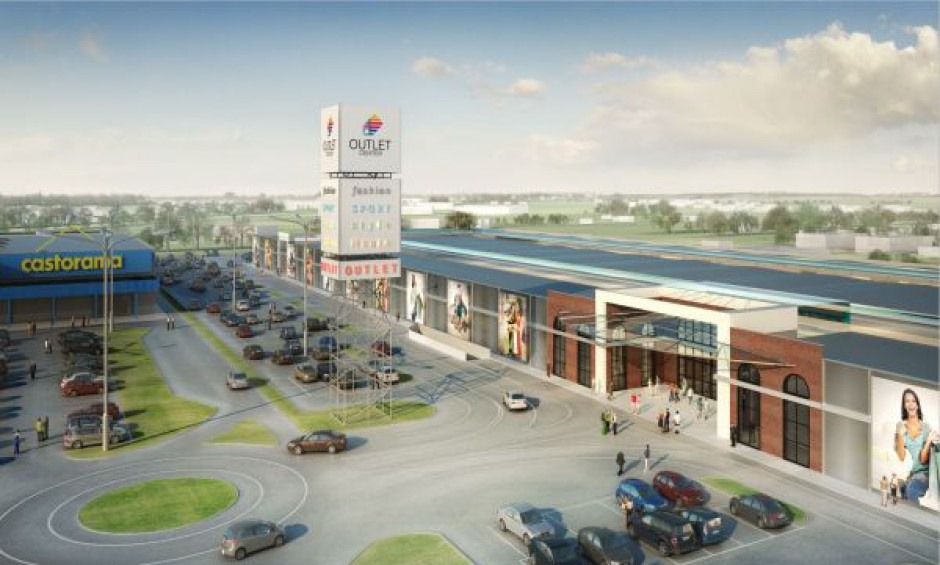 Wizualizacja centrum handlowego typu outlet z parkingiem, widok z lotu ptaka w słoneczny dzień.