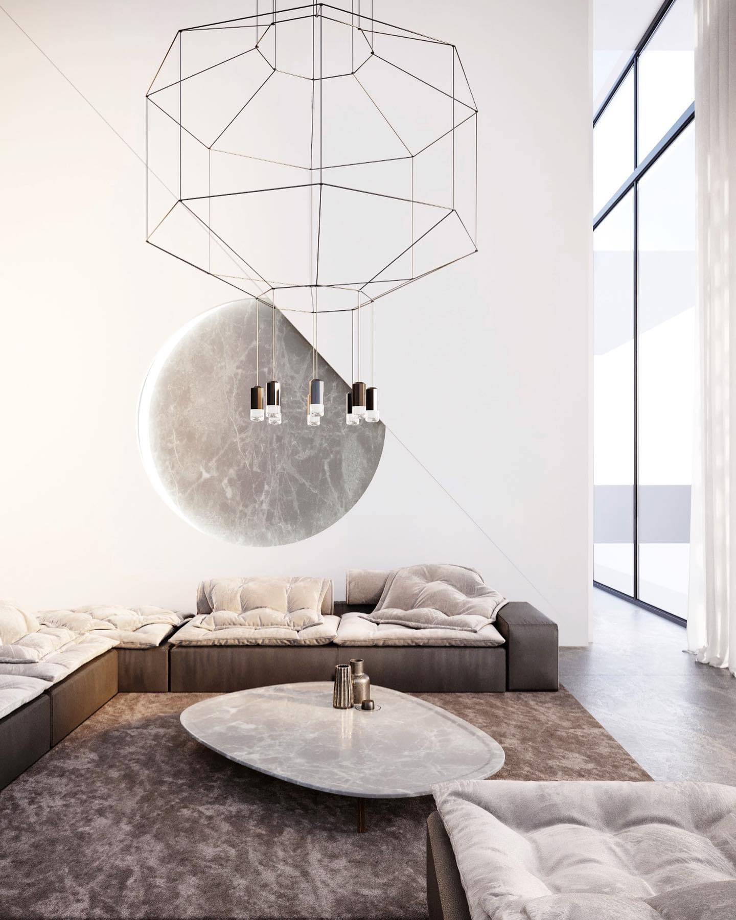 Minimalistyczny salon z narożną sofą w odcieniach szarości, marmurowym stolikiem kawowym, geometryczną lampą wiszącą i okrągłą dekoracją ścienną z efektem marmuru.