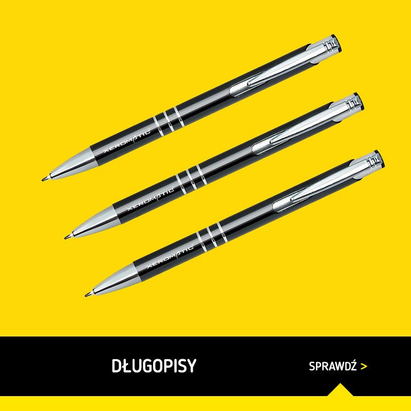 Trzy czarne długopisy z srebrnymi elementami ułożone równolegle na żółtym tle, z widocznym napisem 'XEROMATIC' na każdym z nich.