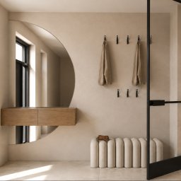 HouseOfDesign - Minimalistyczny przedpokój z beżową ścianą, dużym lustrem w kształcie półkola nad wiszącą drewnianą szafką, ryflowaną ławką i czarnymi wieszakami. Naturalne światło podkreśla tekstury.