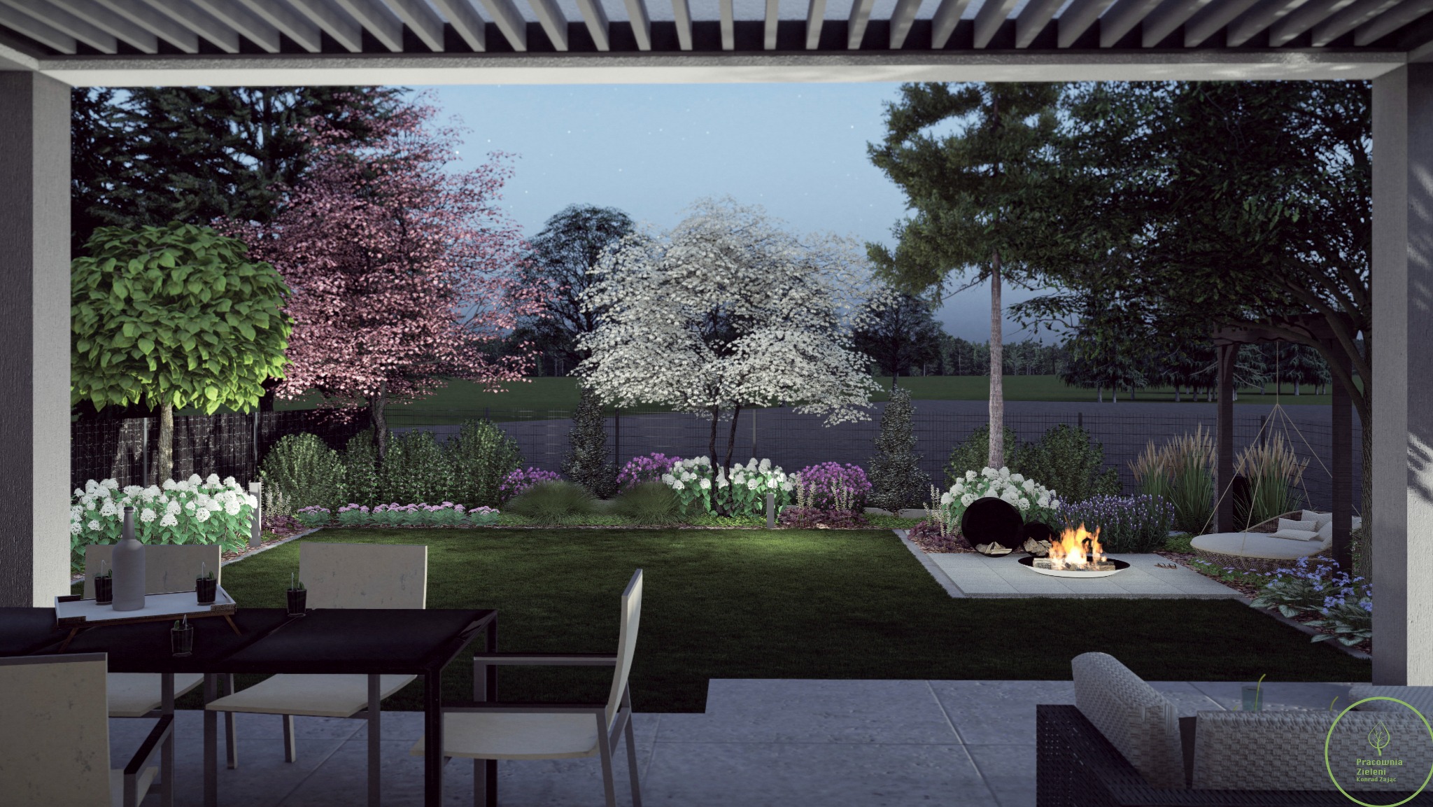 Ogród nocą z paleniskiem, widok z tarasu. Kwitnące drzewa i krzewy, oświetlenie punktowe. Stół z napojami na pierwszym planie. Pergola nad tarasem.