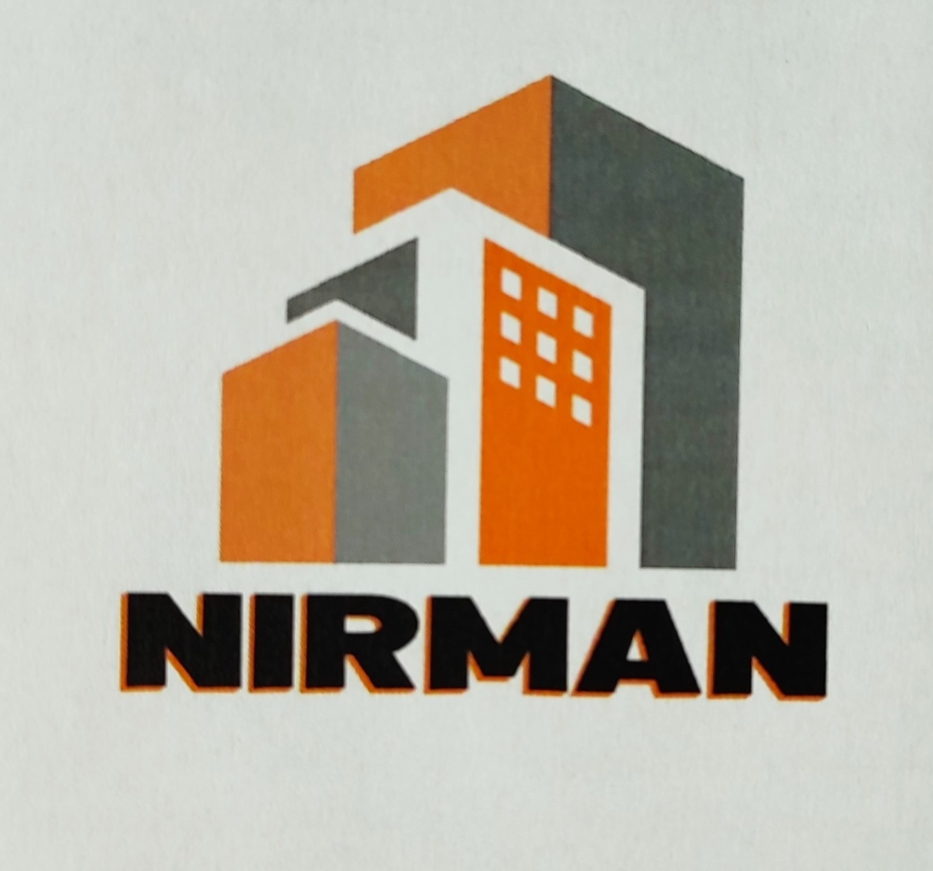 Logo firmy budowlanej NIRMAN przedstawiające stylizowane budynki w kolorach pomarańczowym i szarym na białym tle.