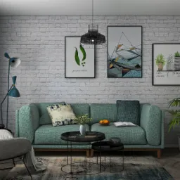 Jasne wnętrze salonu z turkusową sofą, okrągłymi stolikami kawowymi, fotel i lampą podłogową na tle ściany z białej cegły. Na ścianie wiszą trzy grafiki w czarnych ramkach.