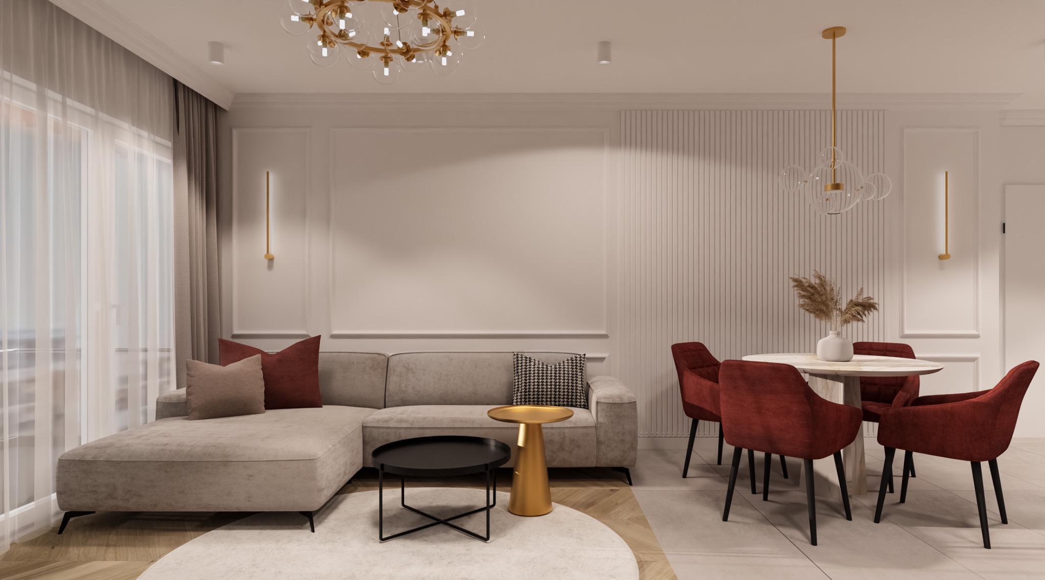 Jasne wnętrze salonu z szarą sofą narożną, okrągłym stolikiem kawowym i jadalnią z okrągłym stołem i czerwonymi krzesłami, oświetlone złotym żyrandolem i kinkietami.
