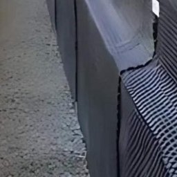 MarkBau - Hydroizolacja fundamentów z użyciem folii kubełkowej, widoczne połączenia i fragment dłoni wskazujący na szczegół konstrukcyjny.