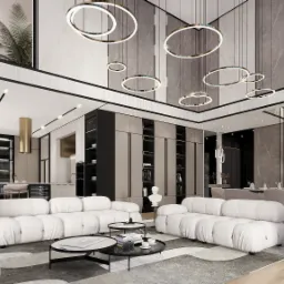 Przestronny salon z białymi modułowymi sofami, marmurowymi ścianami i okrągłymi lampami wiszącymi, widok na jadalnię i kuchnię z barkiem.