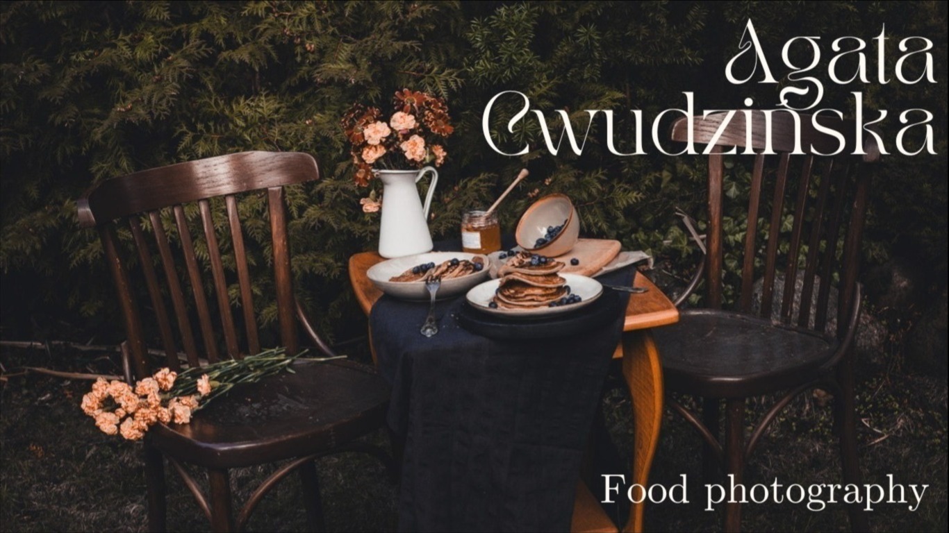 Stylizowane ujęcie stołu z pancakes i borówkami na tle zieleni, z wykorzystaniem drewnianych krzeseł i rustykalnych akcesoriów, w klimacie food photography.