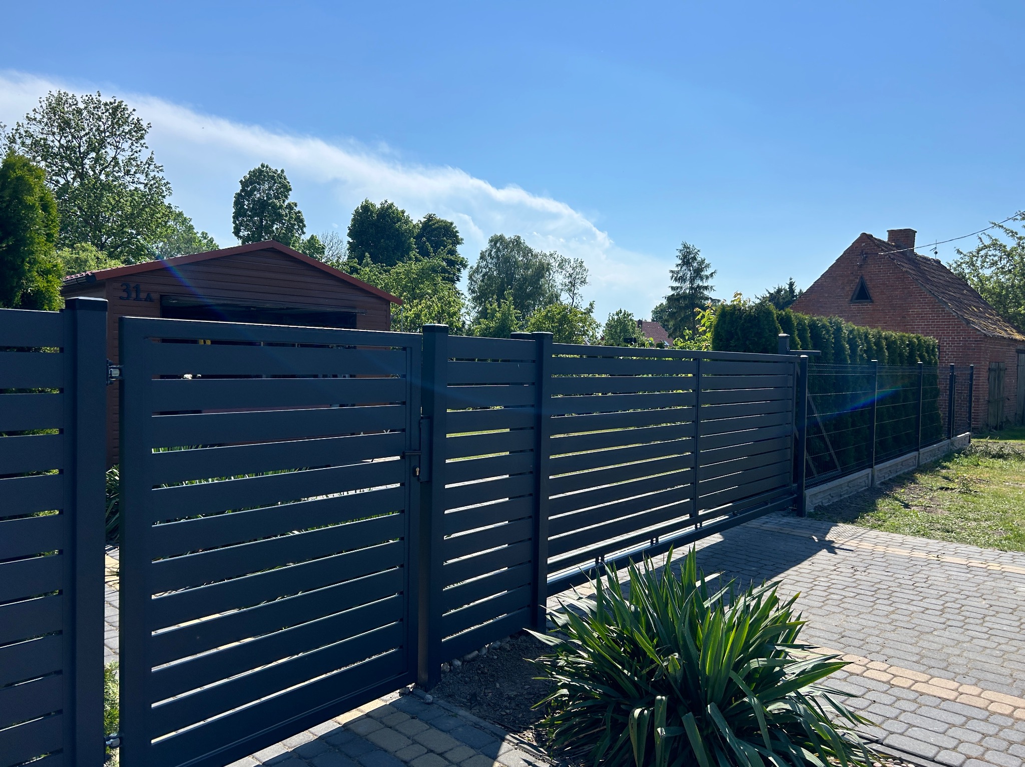 Ogrodzenie palisadowe i częściowo panelowe na podmurówce