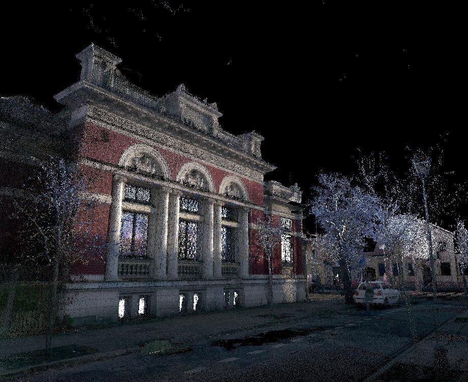 Skan 3D fasady budynku usługowego z kolumnami i dużymi oknami, widzianej nocą z ulicy, z zaparkowanym samochodem w tle.