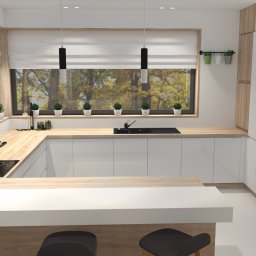 Agmima design sp. z o.o. - Nowoczesna kuchnia z białymi, lakierowanymi szafkami, drewnianym blatem i wyspą z białym blatem. Nad blatem wiszą czarne lampy. Za oknem widok na drzewa w jesiennych barwach. Na parapecie doniczki...