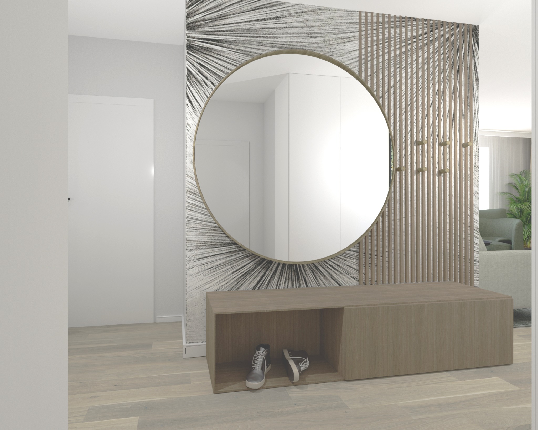 Nowoczesny przedpokój z okrągłym lustrem w złotej ramie, drewnianą ścianką działową z wieszakami i niską szafką na buty, na której leżą dwie pary butów. W tle widoczny salon.