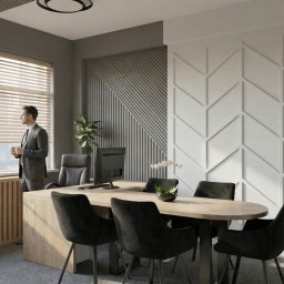 Emilia Kozłowska Projekty z Pasją - Nowoczesne biuro z drewnianym stołem, czarnymi krzesłami i dekoracyjnymi panelami ściennymi. Mężczyzna w garniturze stoi przy oknie.