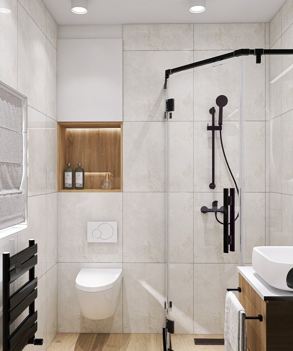Jasna łazienka z kabiną prysznicową typu walk-in, toaletą podwieszaną i drewnianą wnęką z kosmetykami. Minimalistyczny design z akcentami drewna i czerni.