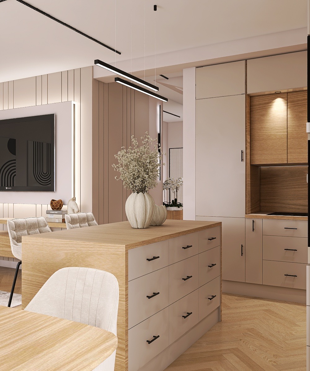 Beżowa kuchnia z wyspą i drewnianymi akcentami. Na wyspie wazon z kwiatami. Minimalistyczne oświetlenie i parkiet w jodełkę. Nowoczesny design.