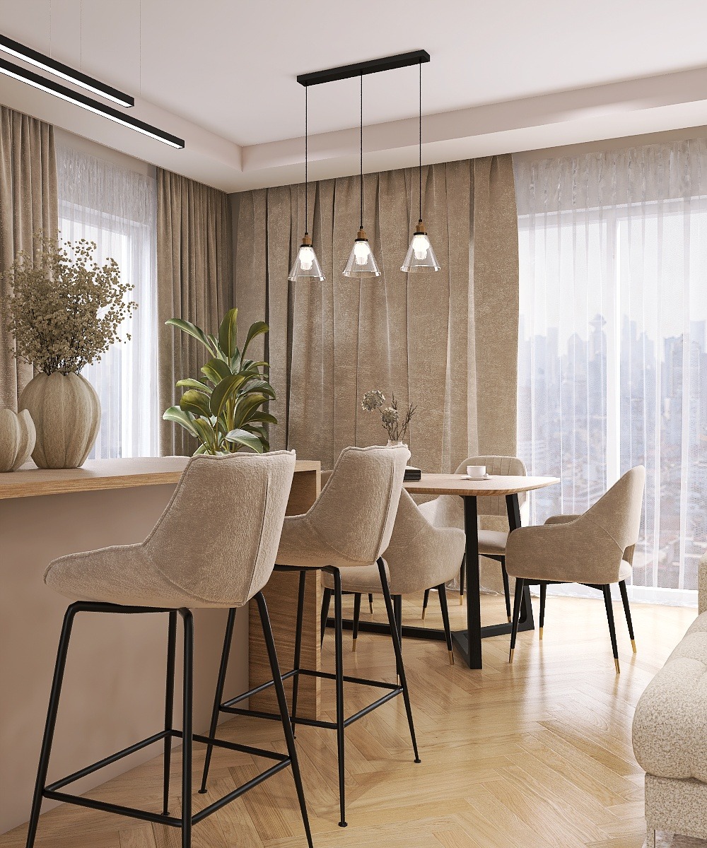 Beżowe krzesła barowe przy wyspie kuchennej, drewniany stół jadalny z krzesłami w tle. Całość w neutralnej kolorystyce, z akcentami roślinnymi i nowoczesnym oświetleniem.