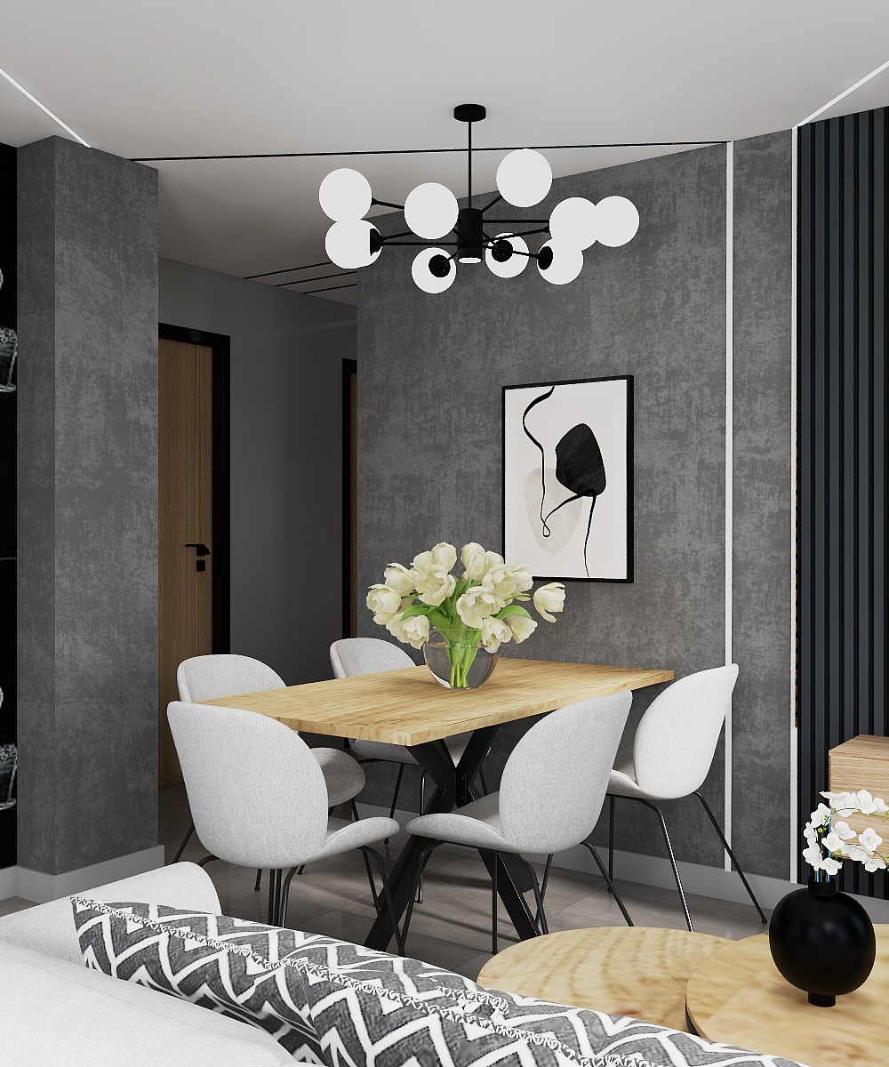 Jasna drewniana jadalnia z białymi krzesłami i modernistyczną lampą, szare ściany z czarnymi akcentami. Nowoczesny design z roślinami.
