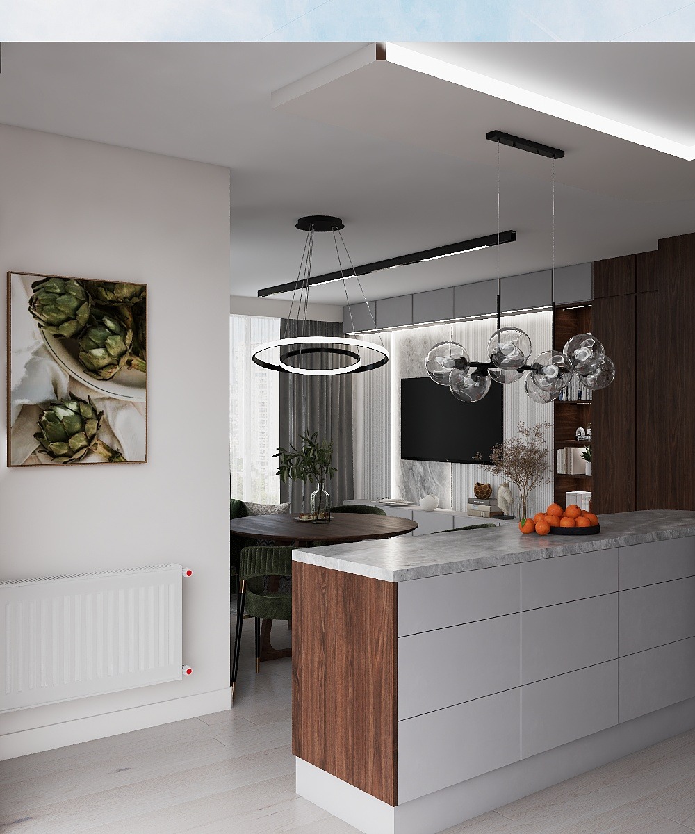 Elegancka kuchnia z wyspą, marmurowym blatem i drewnianymi akcentami. Nowoczesne oświetlenie, obraz z karczochami i zielone krzesła dodają charakteru.
