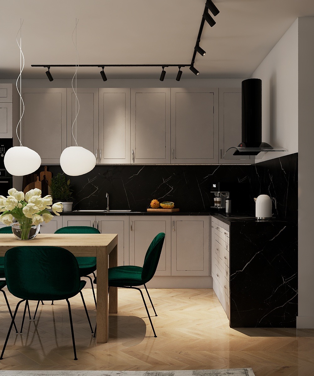 Nowoczesna kuchnia z marmurowym blatem i zielonymi krzesłami. Oświetlenie punktowe podkreśla minimalistyczny design. Na stole wazon z białymi tulipanami.
