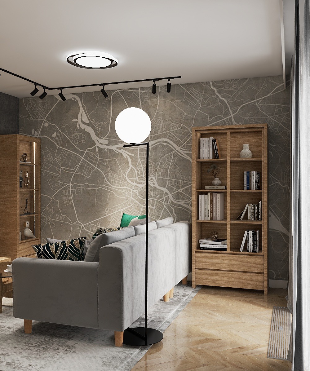 Nowoczesny salon z szarą sofą, drewnianym regałem i lampą kulą na tle ściany z mapą. Oświetlenie szynowe i parkiet w jodełkę dodają wnętrzu charakteru.