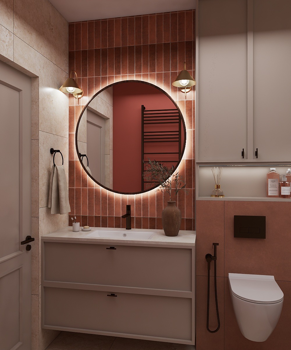 Nowoczesna łazienka z okrągłym lustrem podświetlanym LED, brązowymi płytkami i beżową szafką pod umywalką. Minimalistyczny design z akcentami w stylu retro.