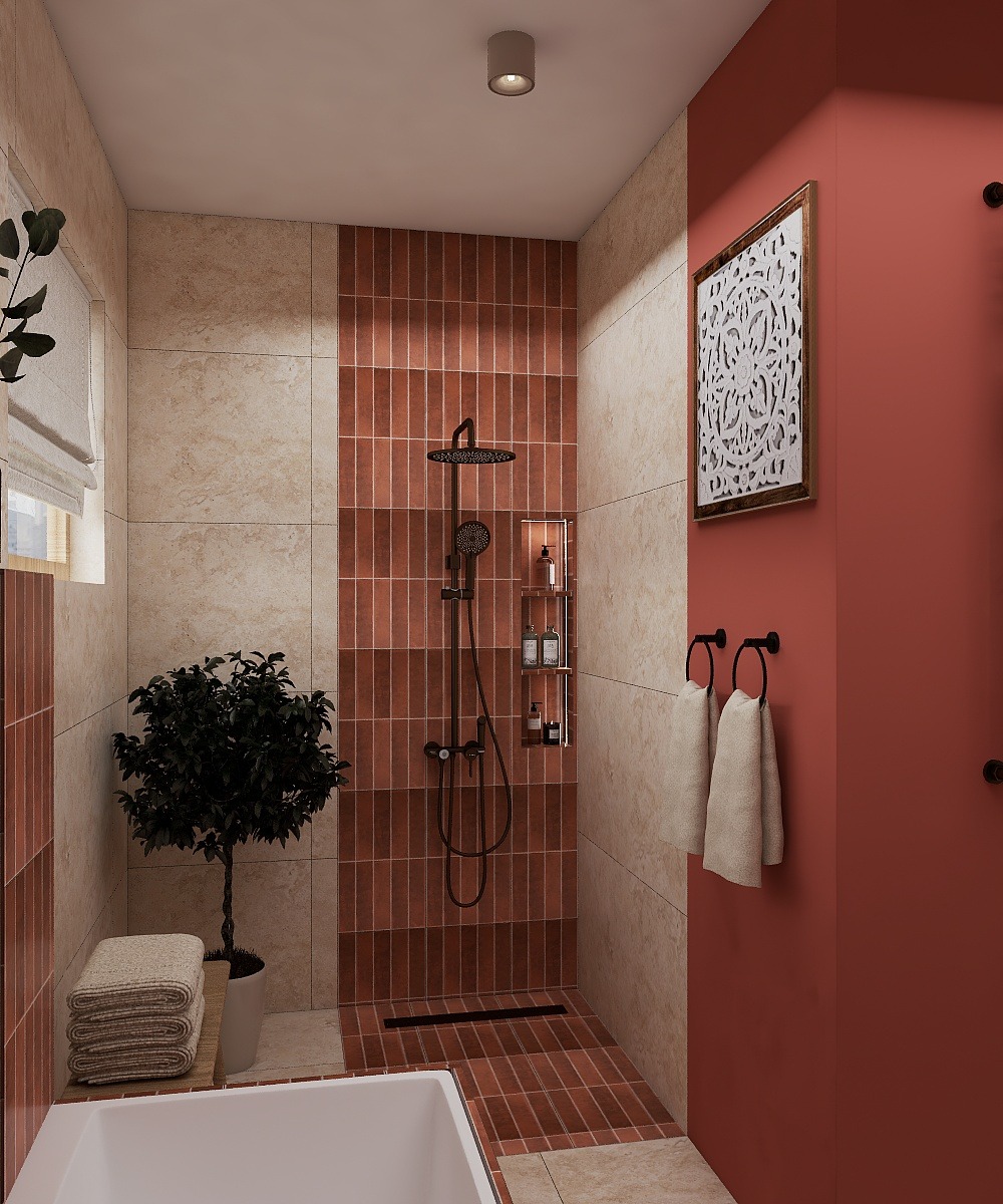 Nowoczesna łazienka z kabiną prysznicową wyłożoną ceglastymi płytkami, czarną armaturą i dekoracyjną grafiką na koralowej ścianie. Minimalistyczny design z rośliną w doniczce.