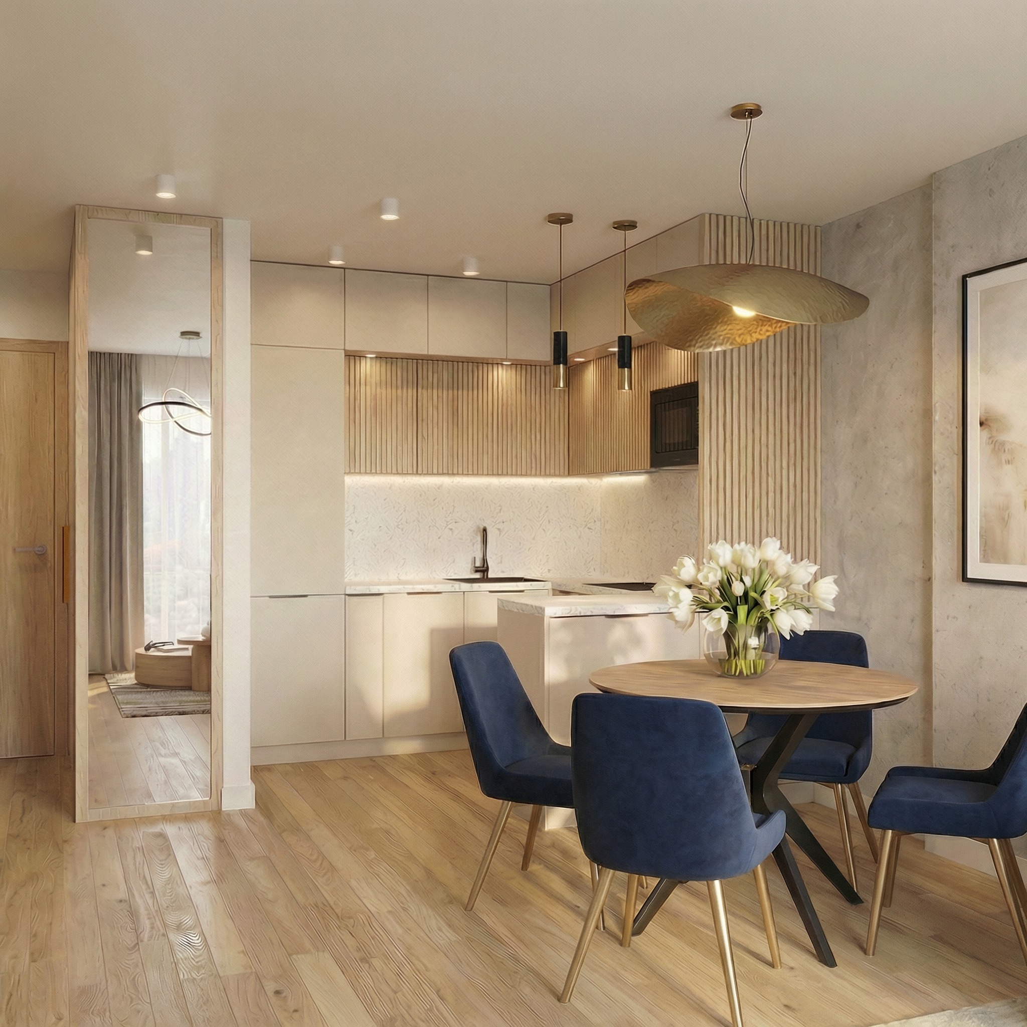 Jasne wnętrze: kuchnia z wyspą, okrągły stół z bukietem białych kwiatów i niebieskimi krzesłami. Lustro w drewnianej ramie odbija salon. Drewniana podłoga.