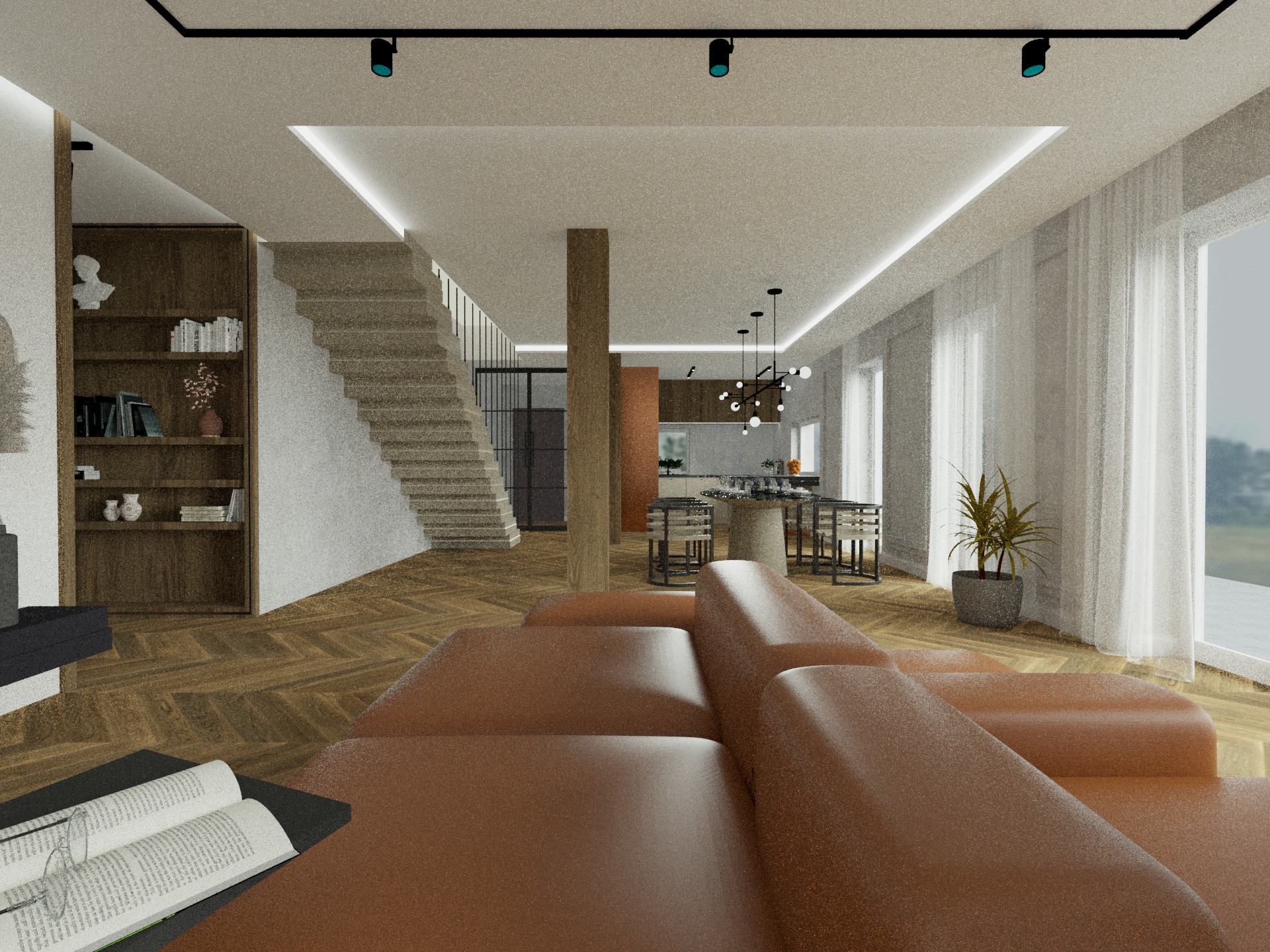 Wnętrze salonu z otwartą kuchnią, brązowa sofa z książką i okularami na stoliku, parkiet w jodełkę, schody z drewnianą półką na książki, widok na stół jadalny i okno z zasłonami.