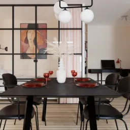 Nowoczesna jadalnia z czarnym stołem, krzesłami i zastawą w odcieniach czerwieni, oddzielona szklaną ścianką działową od sypialni z widocznym łóżkiem i obrazem na ścianie.