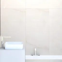 Minimalistyczna łazienka z umywalką nablatową, baterią w kolorze chromu i toaletą, wykończona płytkami imitującymi marmur w odcieniach beżu.