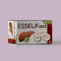 Opakowanie suplementu diety Esseliffast z grafiką wątroby, fosfolipidami sojowymi i witaminami B2+B6 na jasnofioletowym tle.