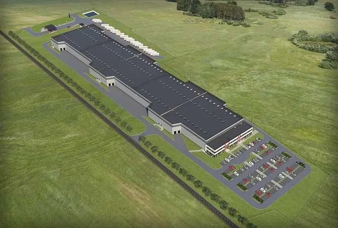 Wizualizacja z lotu ptaka dużego magazynu logistycznego z parkingiem i placem manewrowym dla ciężarówek, otoczonego zielonym terenem.