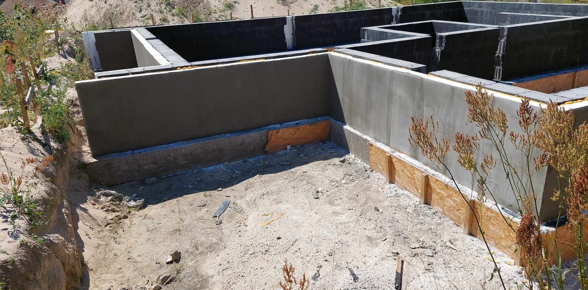 Fundamenty domu jednorodzinnego w Nakle nad Notecią, z widocznymi szalunkami i izolacją termiczną, przygotowane do dalszych prac budowlanych.