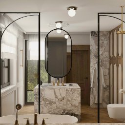 Pina-Studio.pl Natalia Piątkowska - Elegancka łazienka z marmurową umywalką, złotą armaturą i kabiną prysznicową z czarnymi ramami. Widoczne okno i drewniane drzwi. Nowoczesny design.