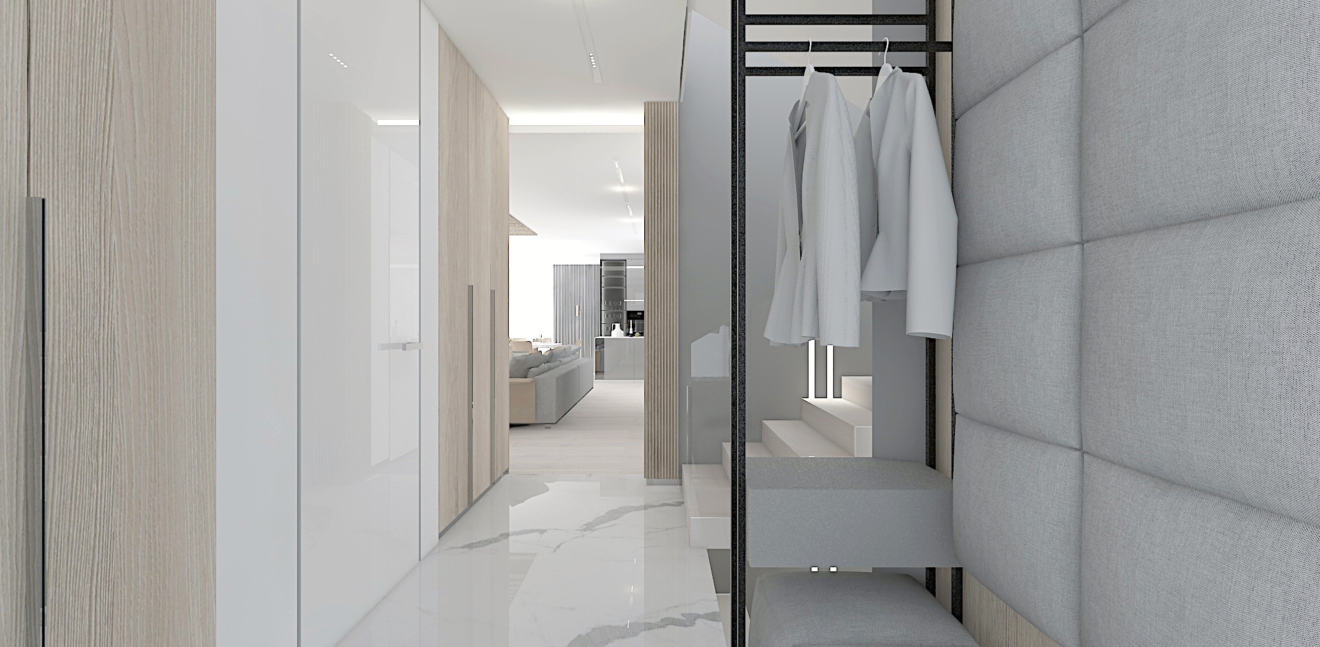 Wnętrze mieszkania w odcieniach szarości i bieli: widok z przedpokoju na salon z sofą, minimalistyczna szafa z wieszakami na ubrania, marmurowa podłoga i panele ścienne.