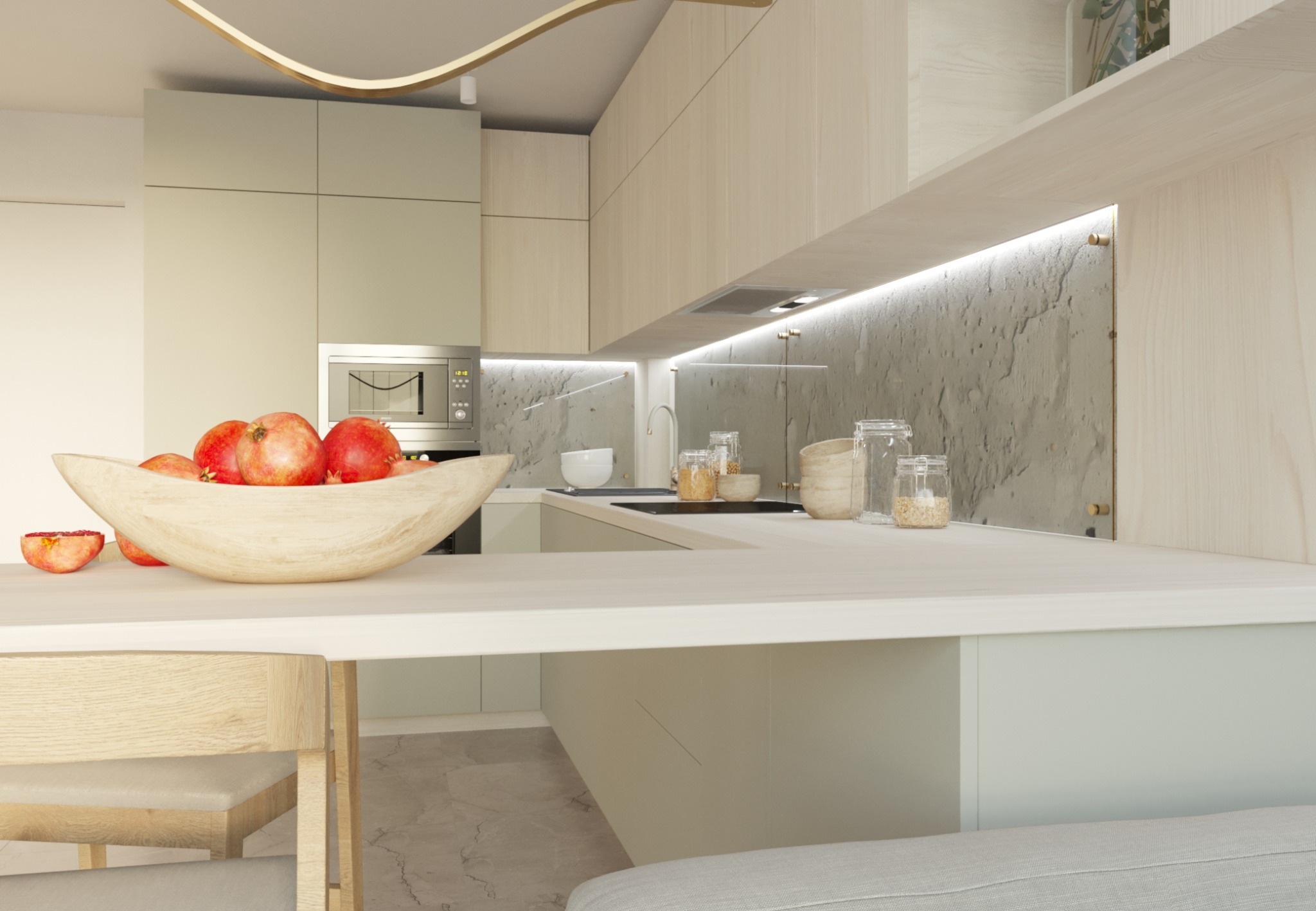 Jasna kuchnia z drewnianymi szafkami, owocami w drewnianej misie na blacie i dekoracyjnym oświetleniem sufitowym.