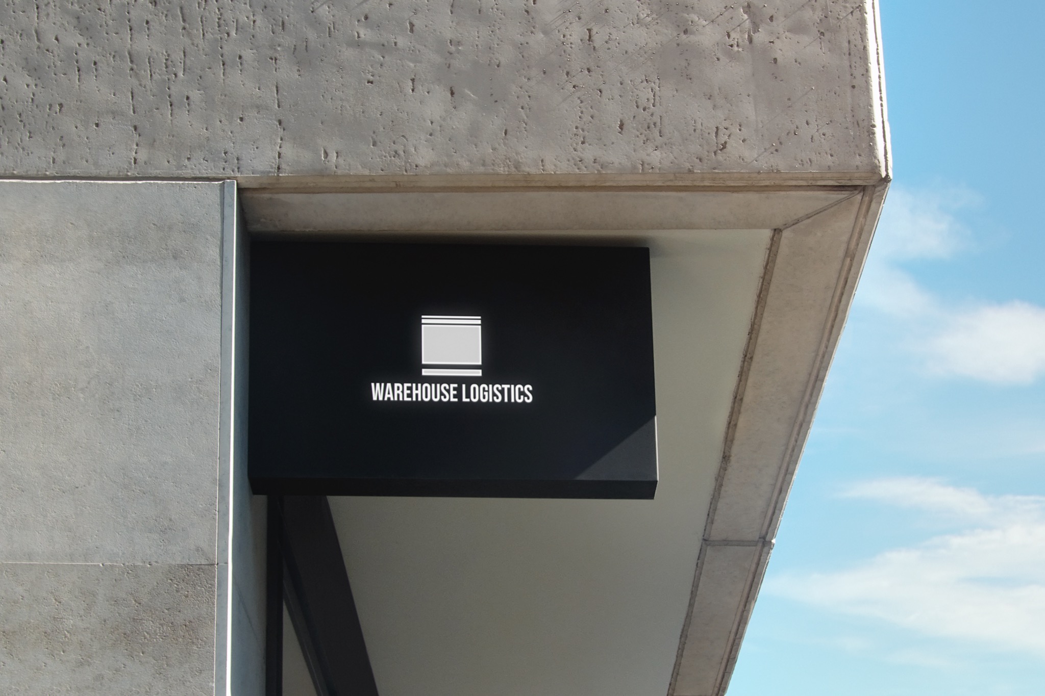 Czarny szyld z białym logo i napisem 'WAREHOUSE LOGISTICS' przymocowany do betonowego budynku, widok z dołu na tle błękitnego nieba.