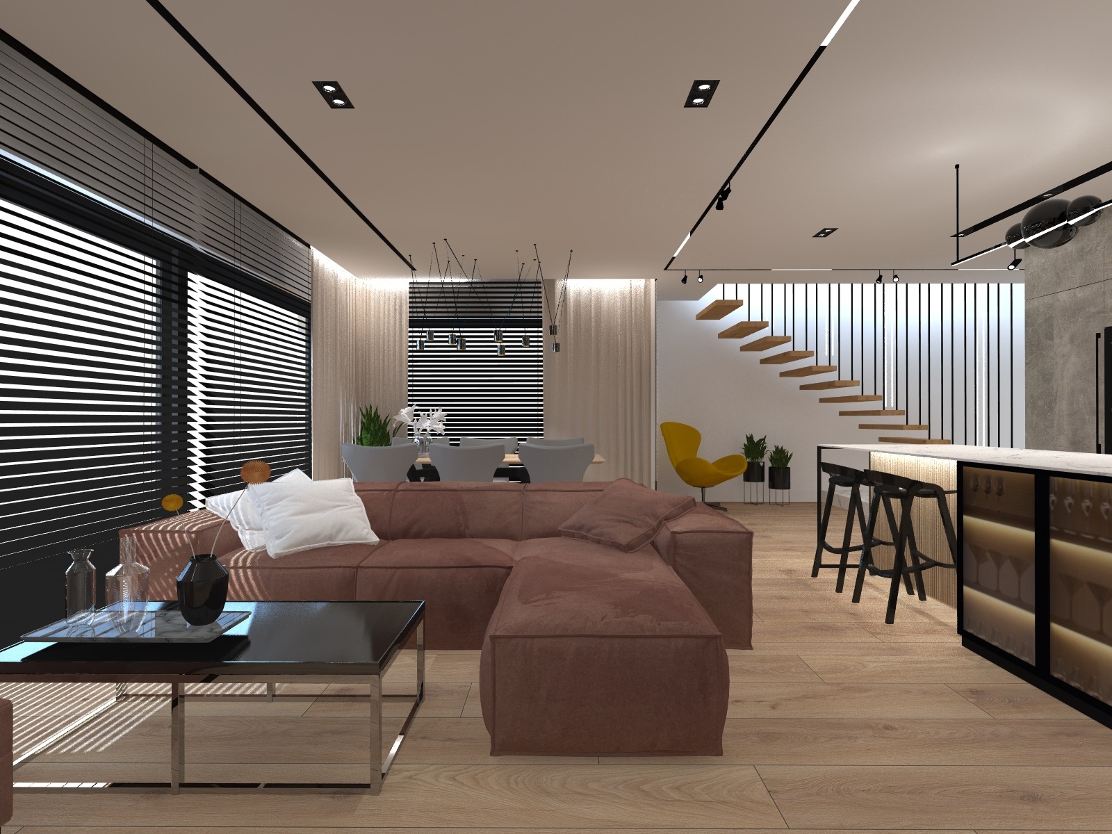 Nowoczesny salon z brązową sofą narożną, stolikiem kawowym z czarnym blatem i metalową ramą, oraz otwartą kuchnią z barkiem i hokerami. W tle widoczne schody i duże okna z żaluzjami.