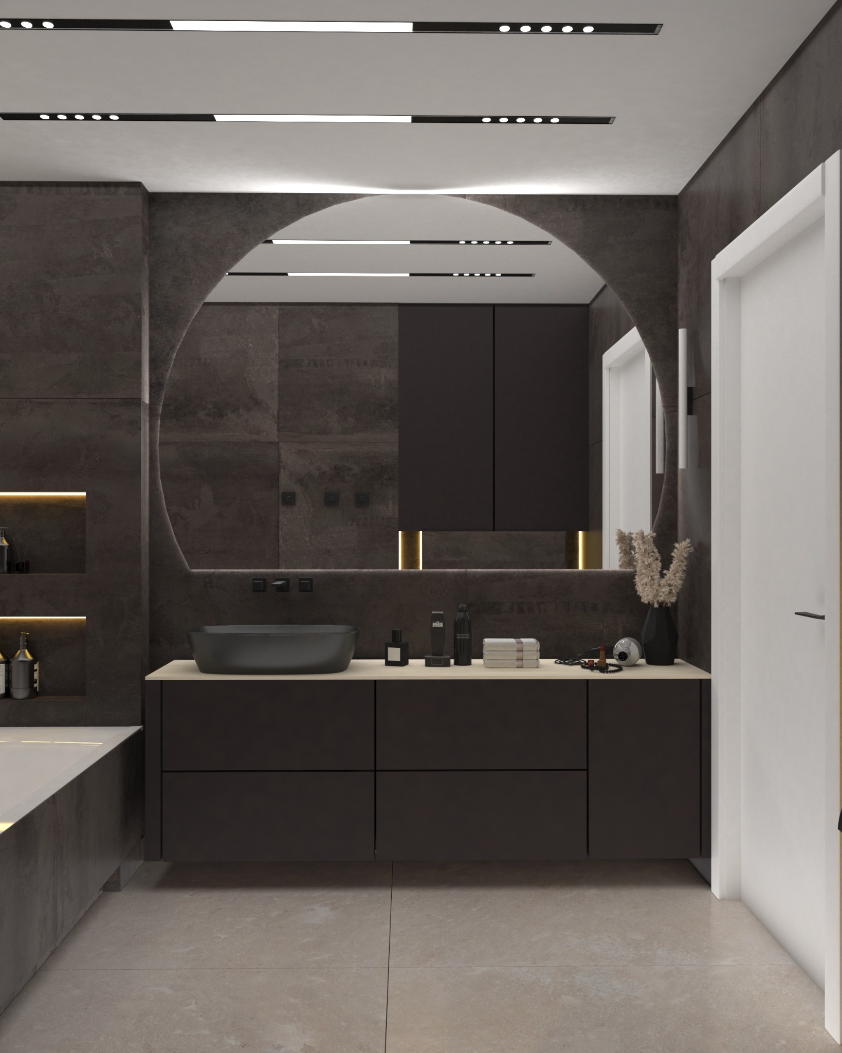 Nowoczesna łazienka z ciemnymi płytkami imitującymi kamień, owalnym lustrem z podświetleniem LED oraz czarną umywalką nablatową i minimalistyczną armaturą. Elementy dekoracyjne: suszone kwiaty...