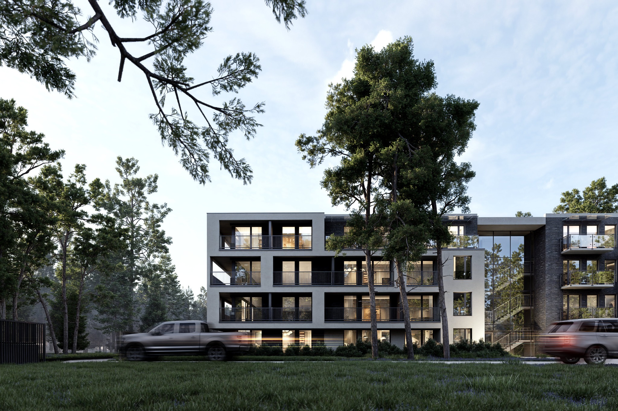 Wizualizacja nowoczesnego apartamentowca z balkonami, otoczonego zielenią i drzewami. Ujęcie z poziomu trawnika, z przejeżdżającymi samochodami.
