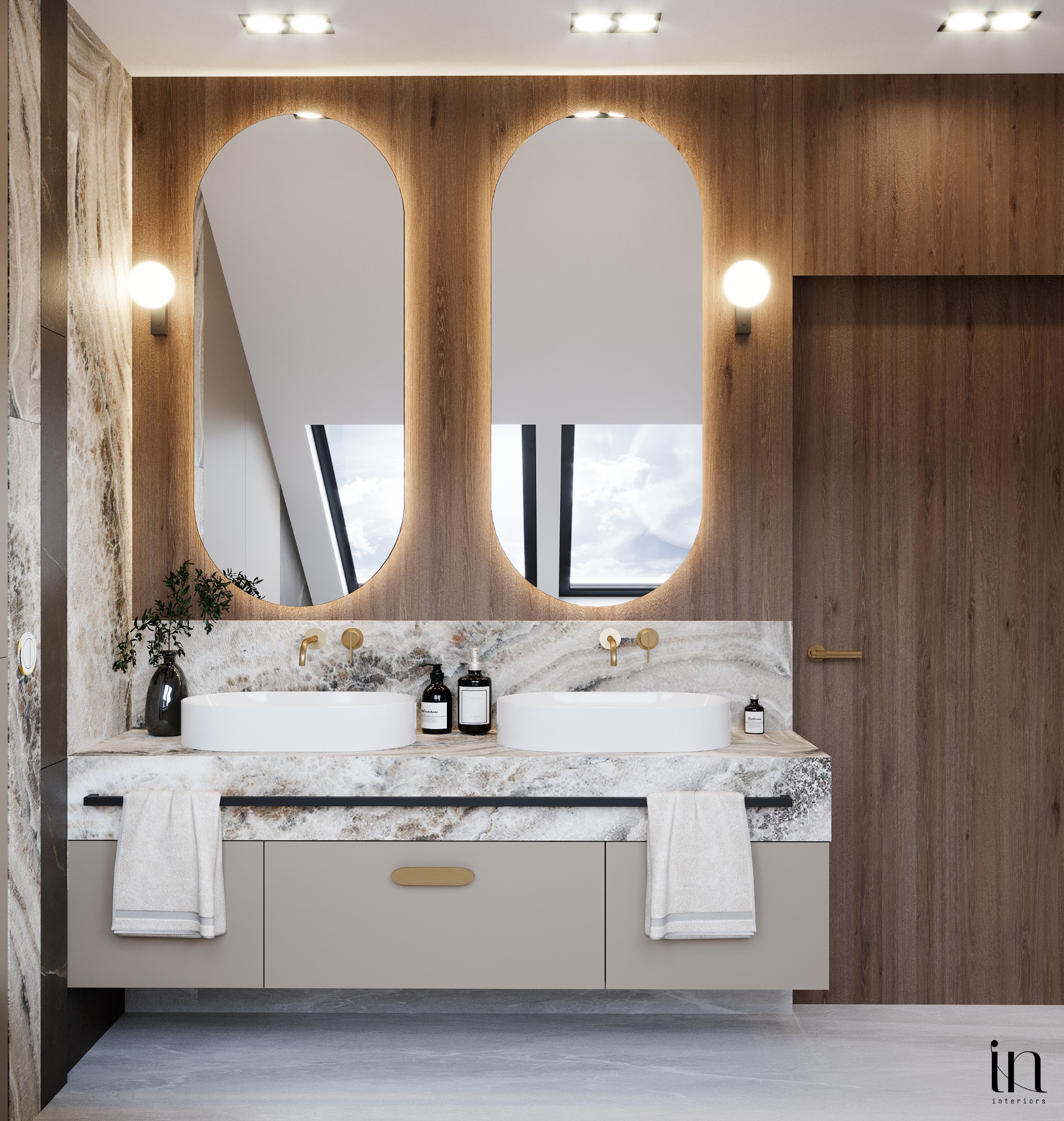 Nowoczesna łazienka z dwoma umywalkami nablatowymi, marmurowym blatem, owalnymi lustrami z podświetleniem LED, drewnianą okładziną ścienną i szarą szafką pod umywalką z złotymi uchwytami.