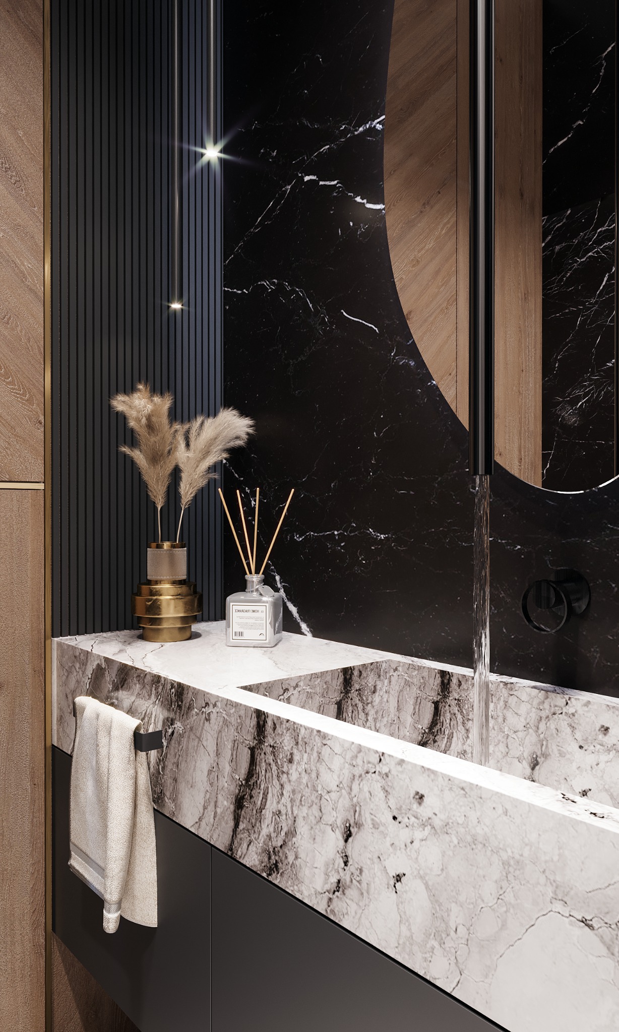 Czarno-biała marmurowa umywalka z wylewającą się wodą, czarne marmurowe ściany z owalnym lustrem, dekoracje z suszonych traw w złotym wazonie i dyfuzor zapachowy.